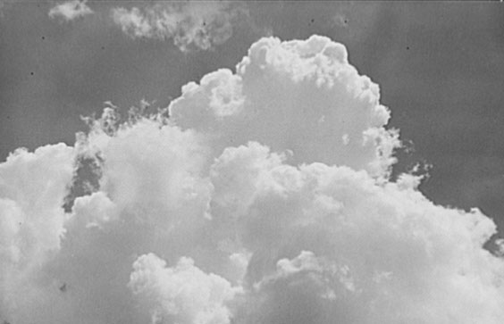 Black and white image of a cloud billowing up in the sky