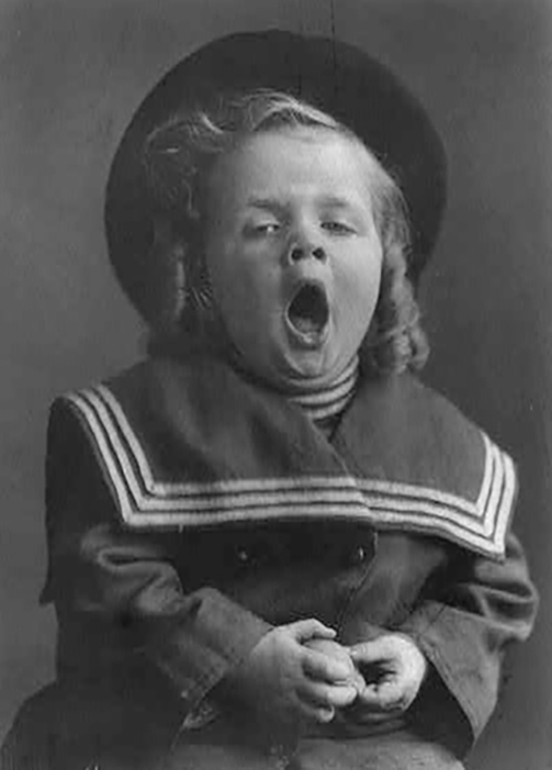 Small boy with long hair wearing hat and sailor coat, yawning. Glen Walker, photographer, 1909. Prints & Photographs Div