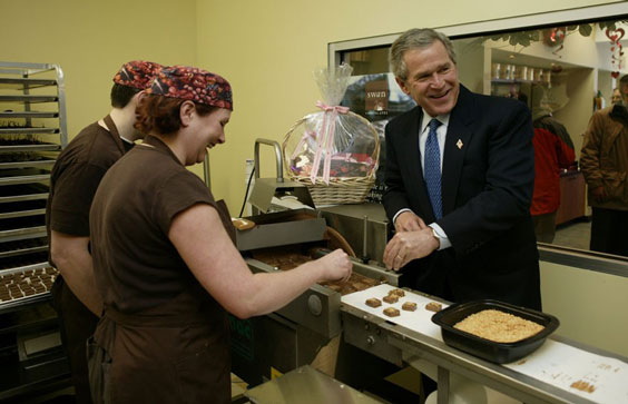 President George W. Bush Helps Make Chocolate Candy While Visiting Swan Chocolates in Merrimack, New Hampshire. 2004. Pa