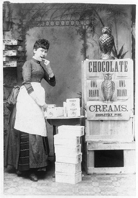 Eating Chocolate. Advertisement showing a woman eating McCobb’s Owl Brand chocolate creams; owls are prominently feature