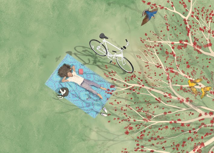 Girl on mat looking up at tree