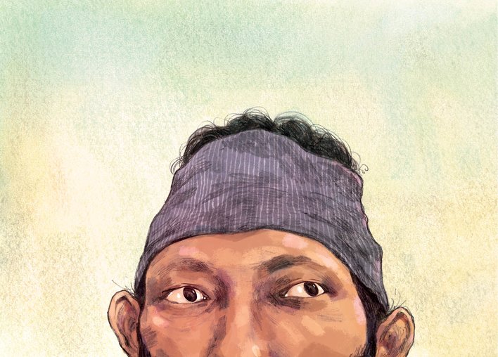 A close up of Ajay's face as he pays attention to life in the forest