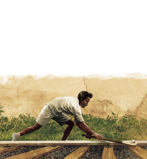 A man playing hockey on the railway tracks