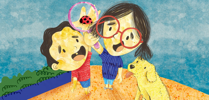 Boy with a girl holding a magnifying glass