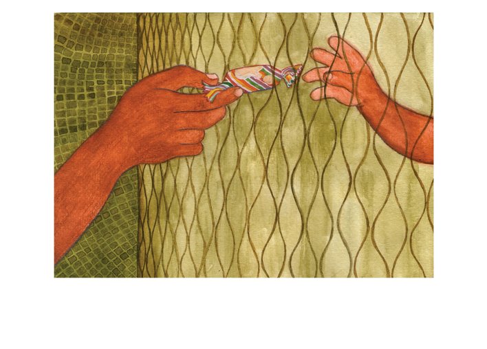 A hand passing a toffee to another through a metal grill