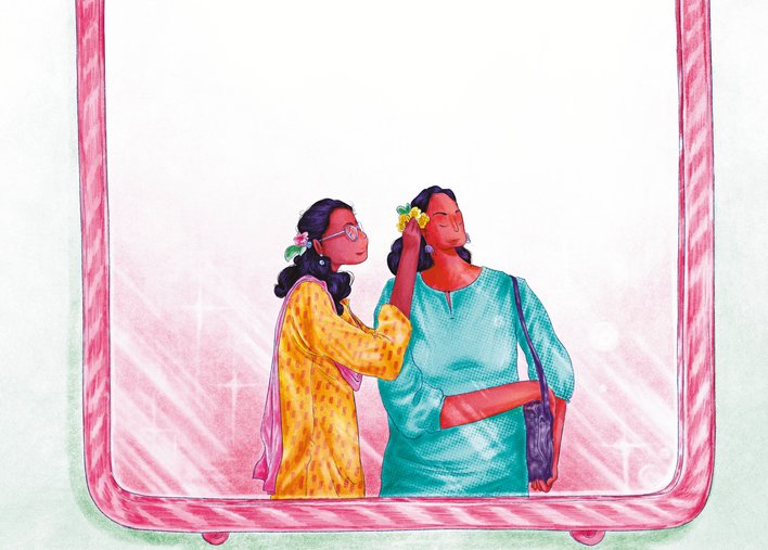 Woman tucking a flower behind the ear of another woman