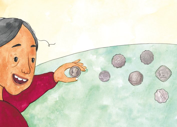 Grandmother holding up an Indian coin