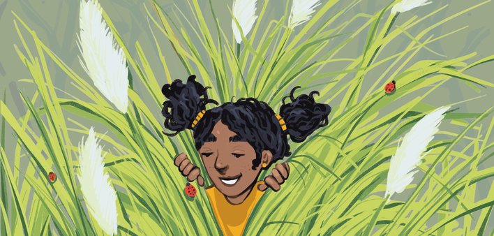 A girl peeping out of grass
