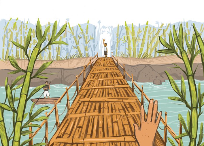 Boy crossing a bamboo bridge