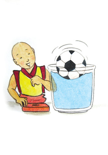 A boy looking at a football floating