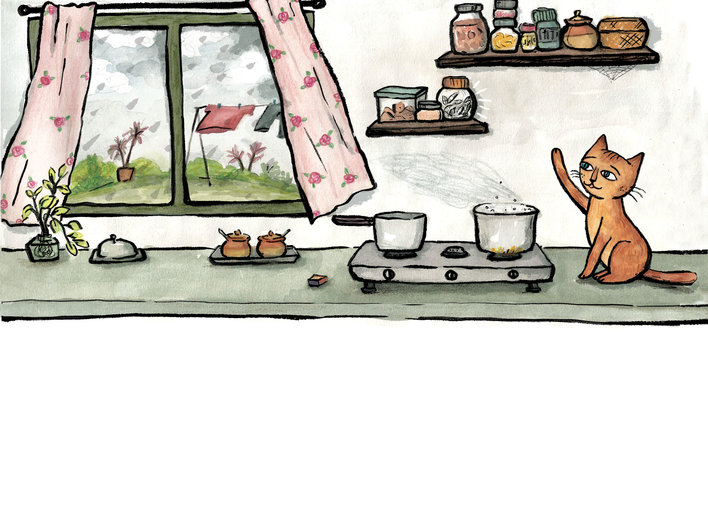 Cat sitting beside the stove