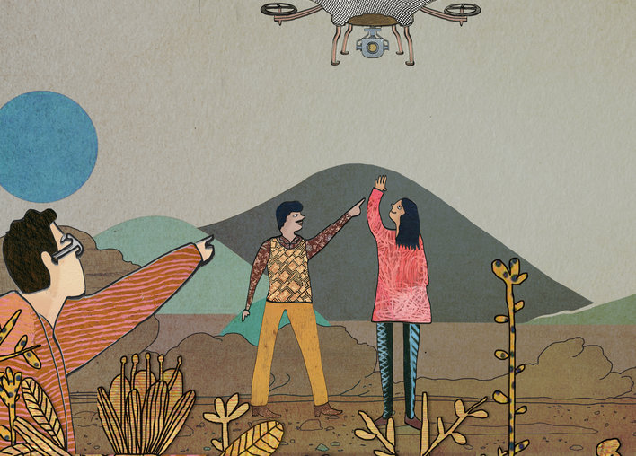 People pointing at a drone