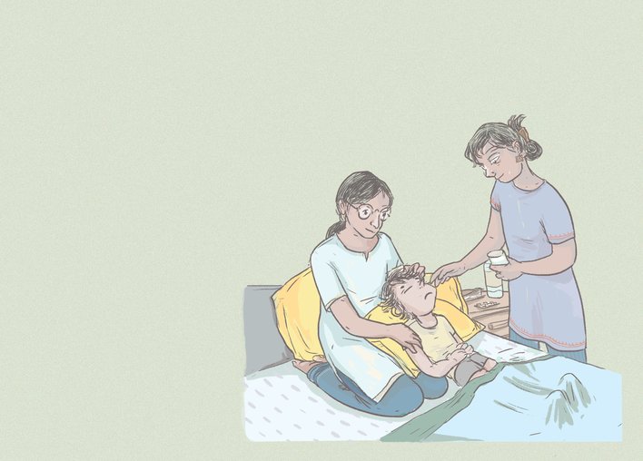 A sick boy being attended to by a caretaker