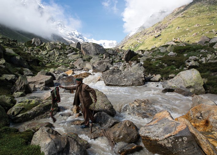 Old man by a gushing river