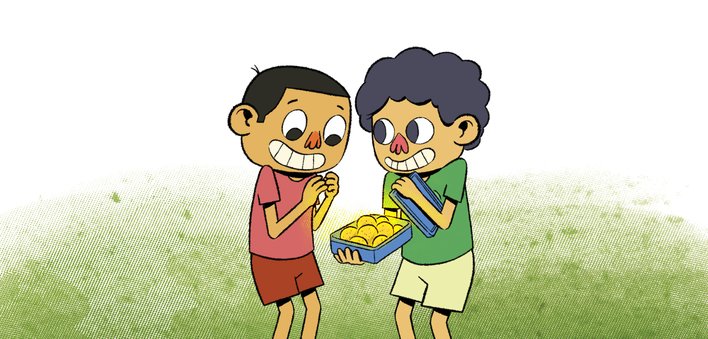 Two boys look at a box of laddoos