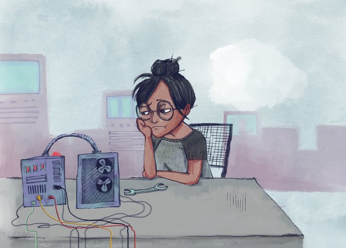 Woman sitting in an engineering lab looking upset