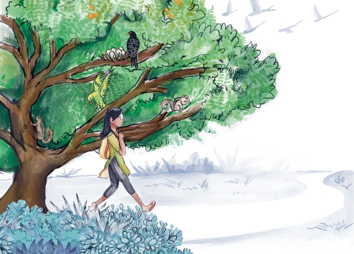 A woman walking next to large tree