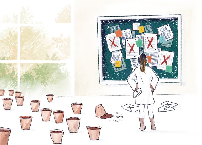 Woman looking at a bulletin board filled with papers and failed ideas