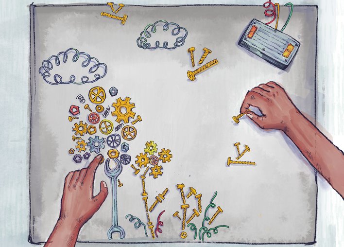 Woman arranging nuts bolts gears and wires to form a landscape