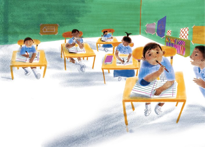 Boy sitting in a classroom looking lost