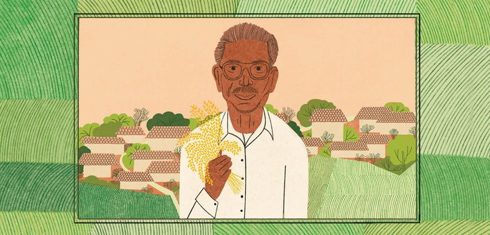 Dadaji Khobragade holding rice crop with fields in the background