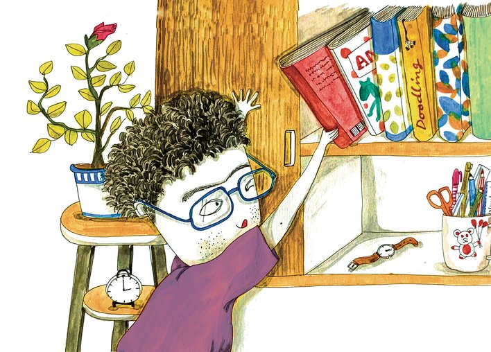 A child pulling out a book from a bookshelf