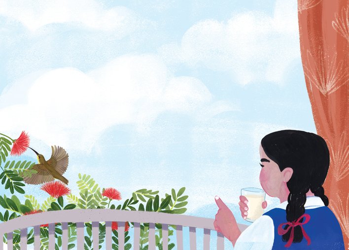 A girl holding a glass of milk pointing at a sunbird eating nectar from a flower
